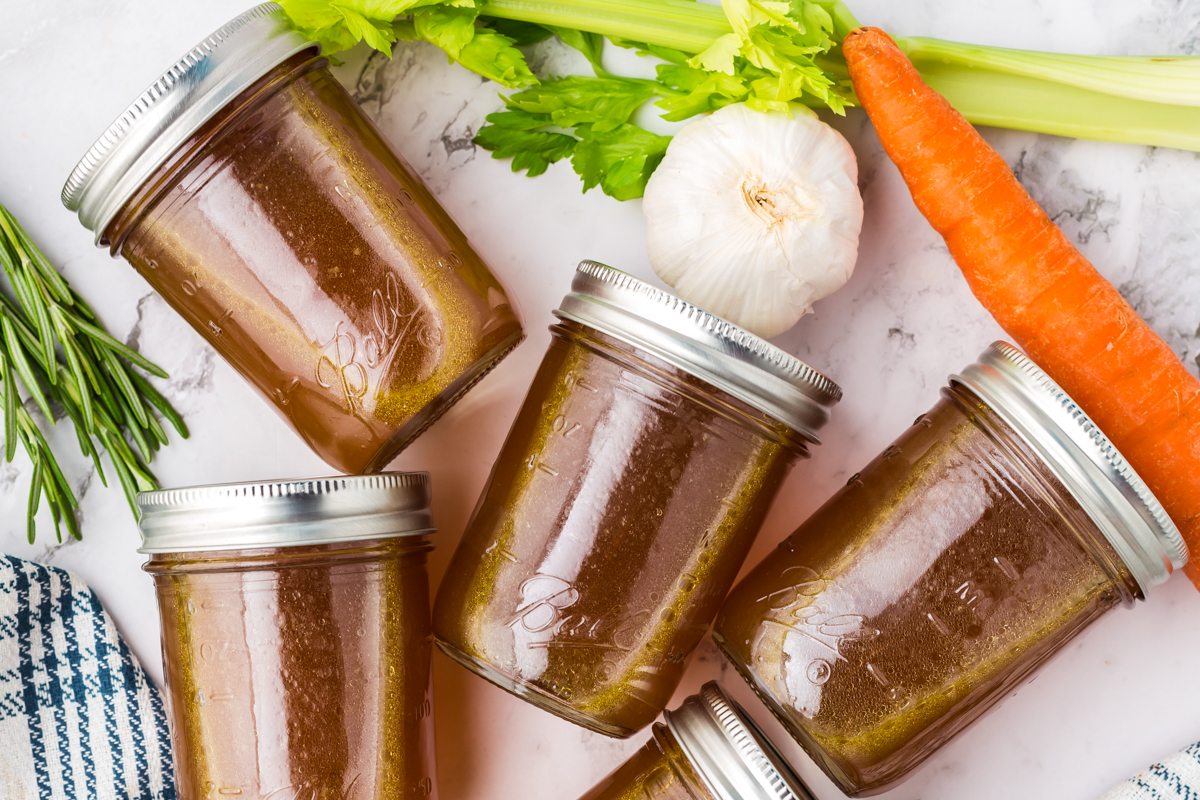 overhead shot of chicken broth in jars.