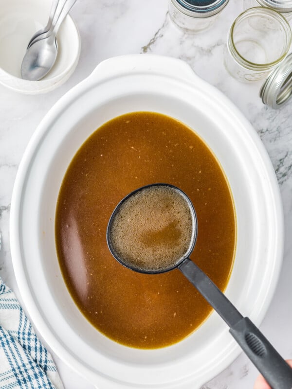 Chicken stock cooked in a slow cooker.