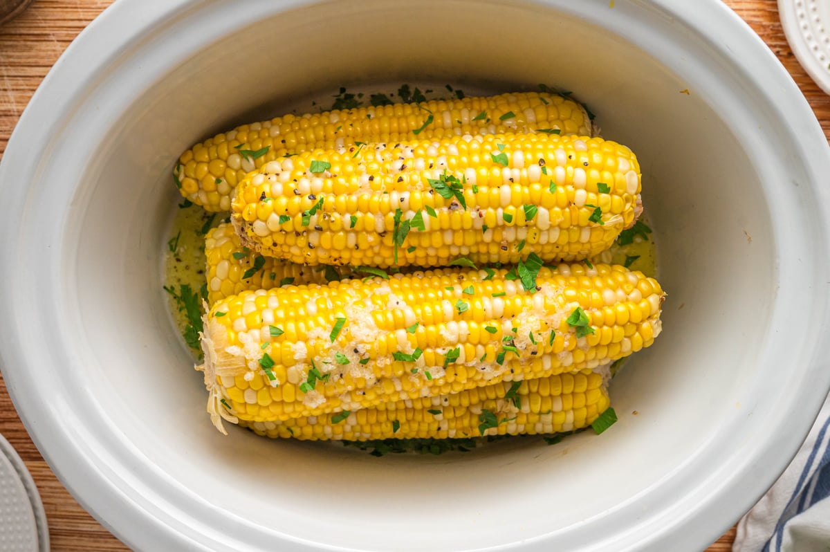 overhead shot of corn on the cob in a slow cooker.