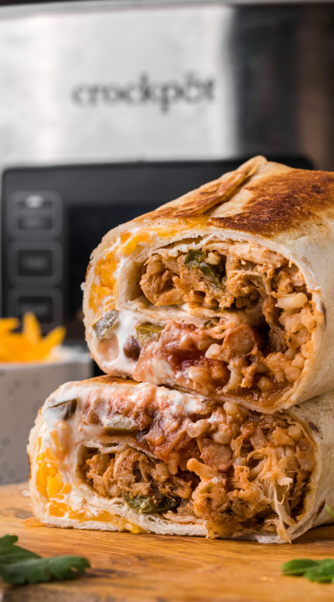 Long images of a cut chicken burrito.