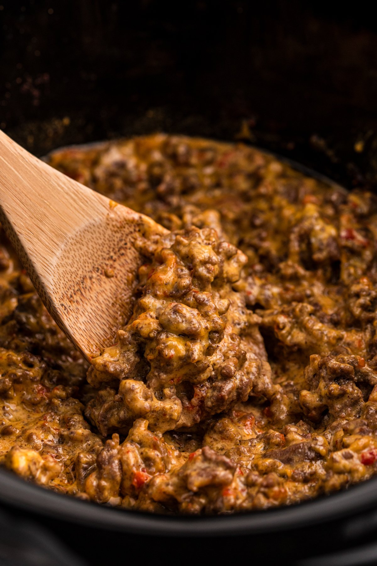 Ground beef and rotel with velveeta cheese in a crockpot.