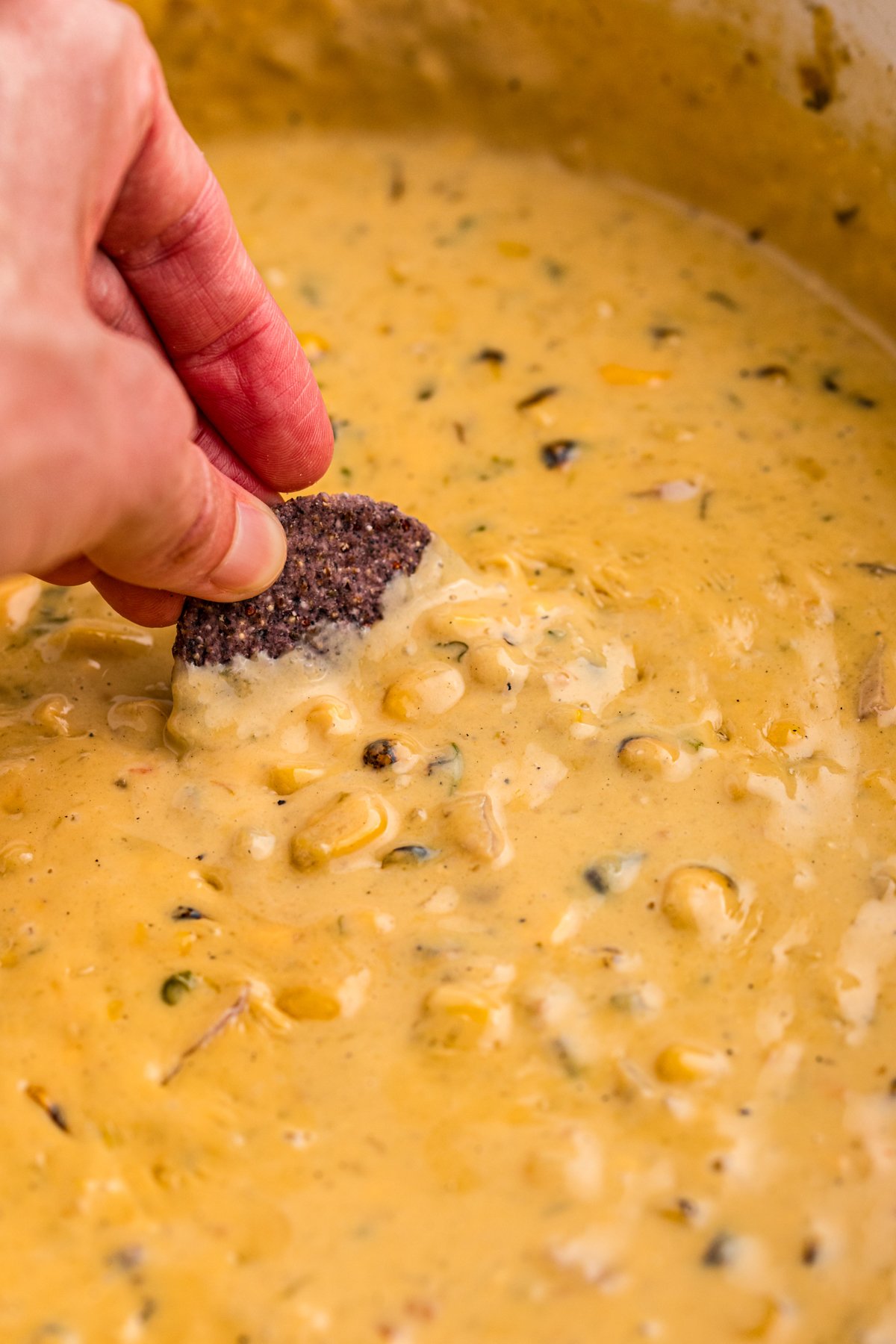 chip being dipped into corn dip.