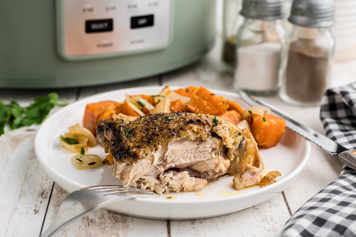 A chicken thigh that has been cut into on a plate.