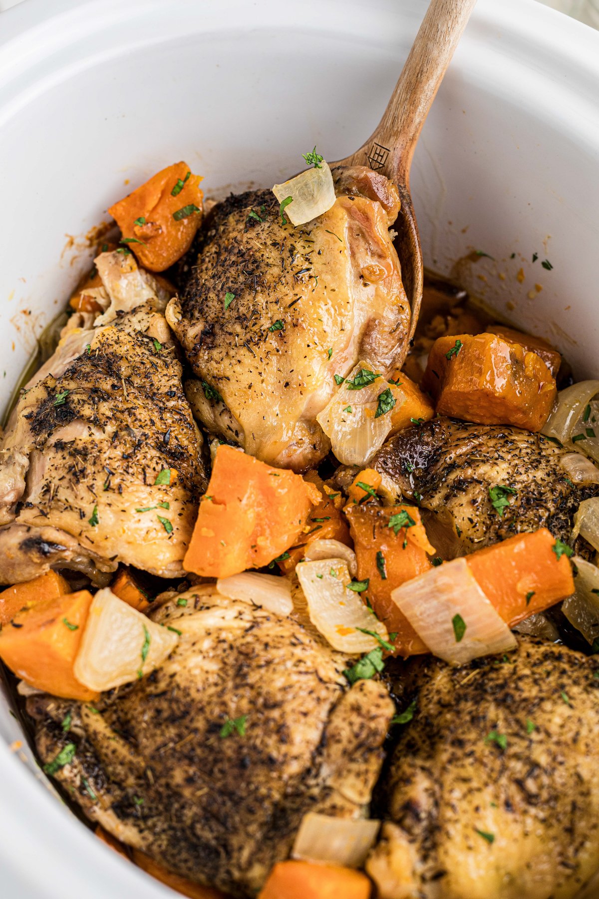 Chicken thighs with sweet potatoes and onions.