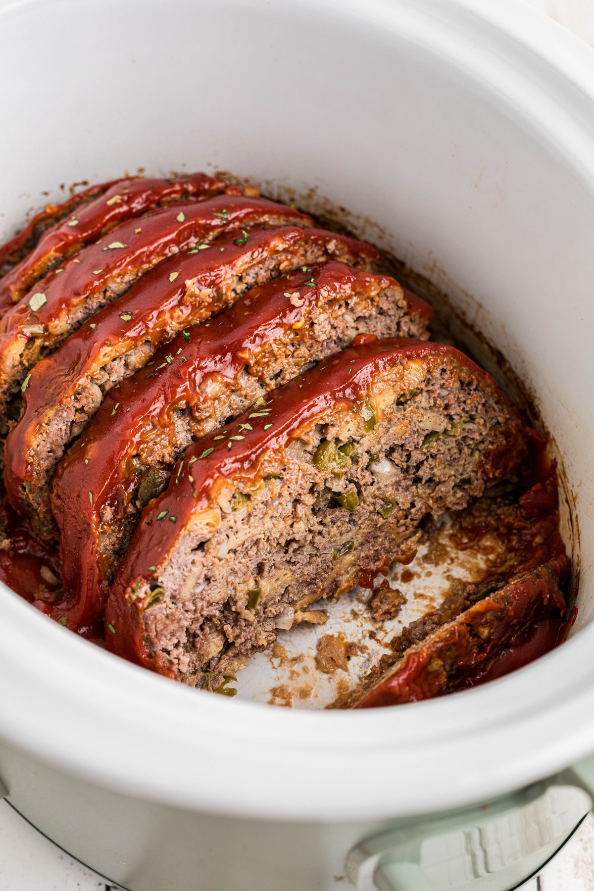 sliced meatloaf in a slow cooker.