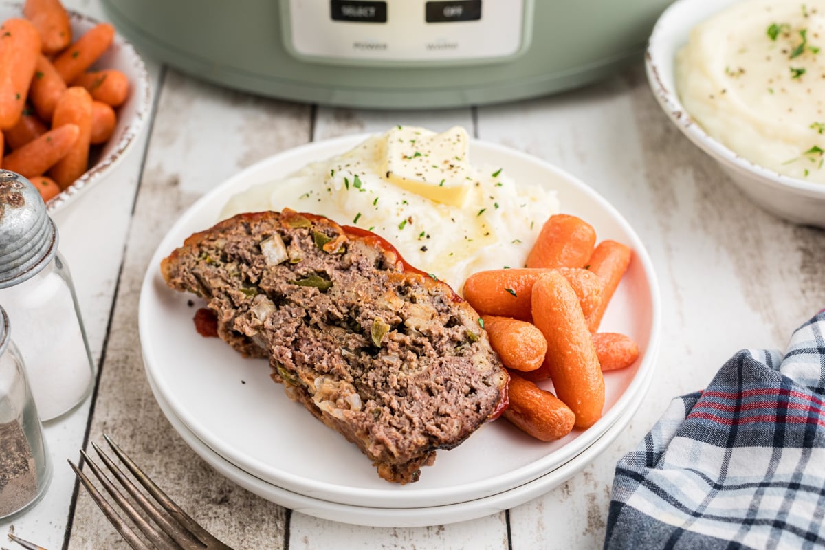 sliced meatloaf, mashed potatoes and carrots.