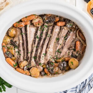 Overhead shot of jack daniels pot roast in a slow cooker.