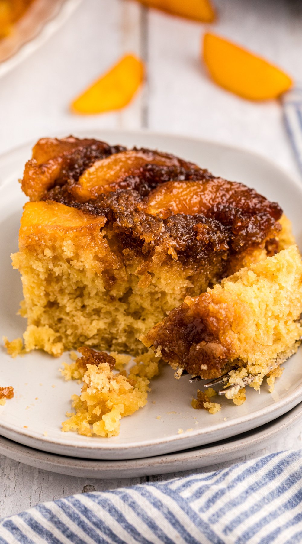 Long image of peach upside down cake.