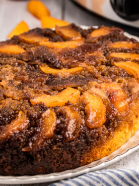 Peach upside down cake on a platter.