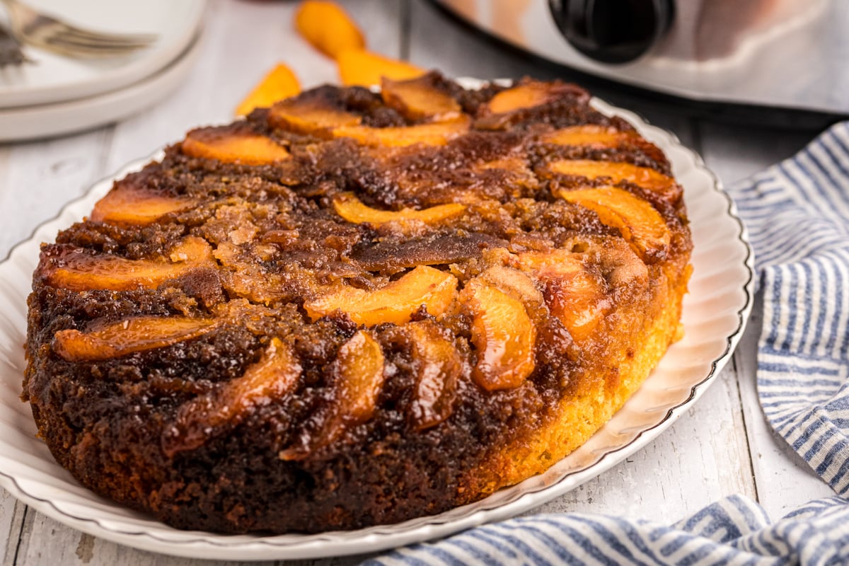 Peach upside down cake on a platter.