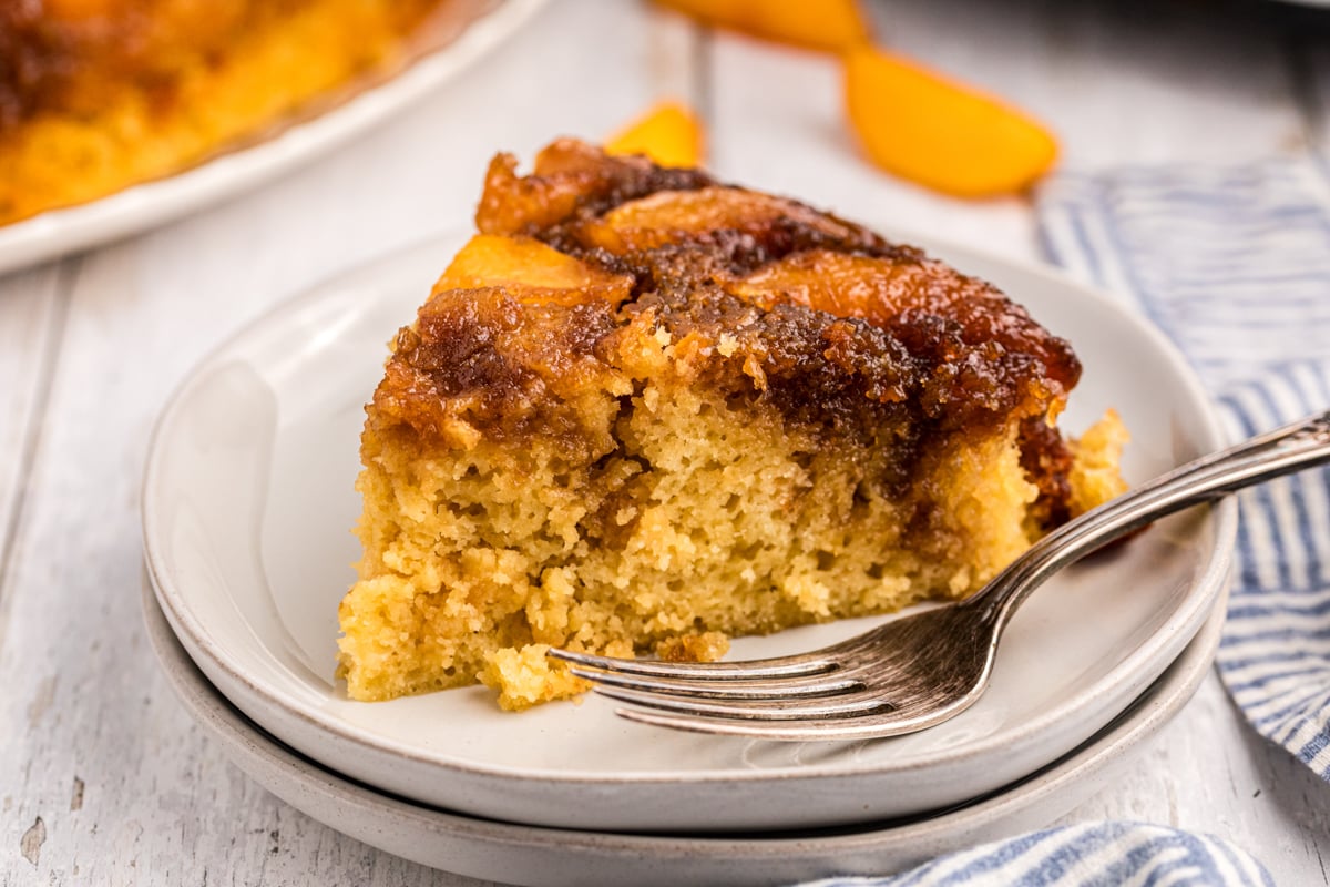 slice of peach cake on a white plate.