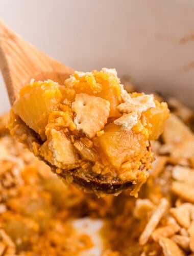 close up of pineapple casseroel on a spoon.