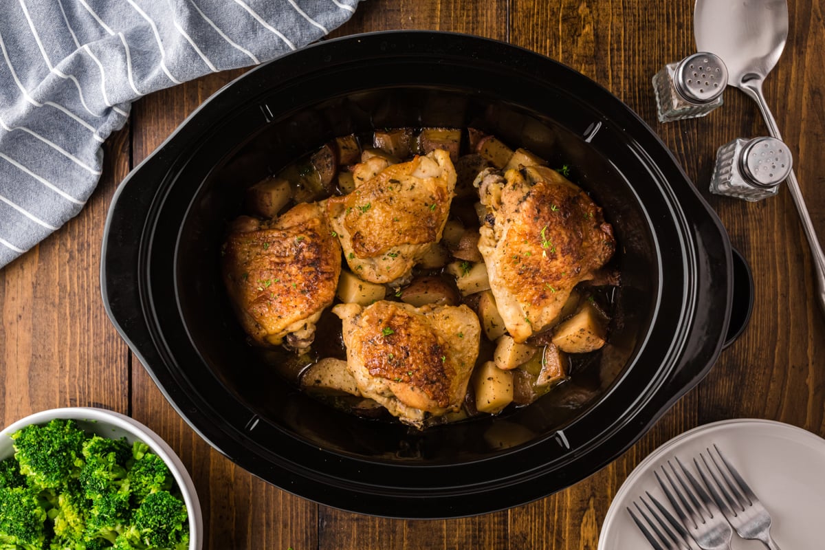 overhead shot of ranch chicken and potatoes in a black slow cooker.