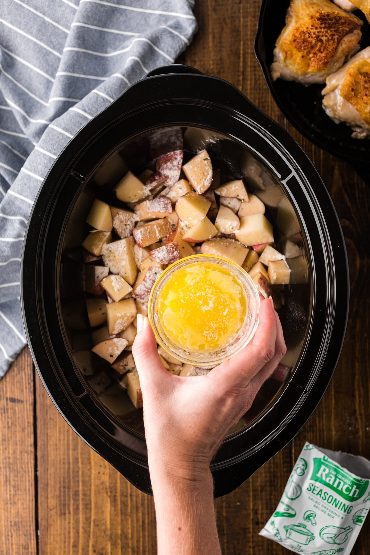 red potatoes with butter being poured over.