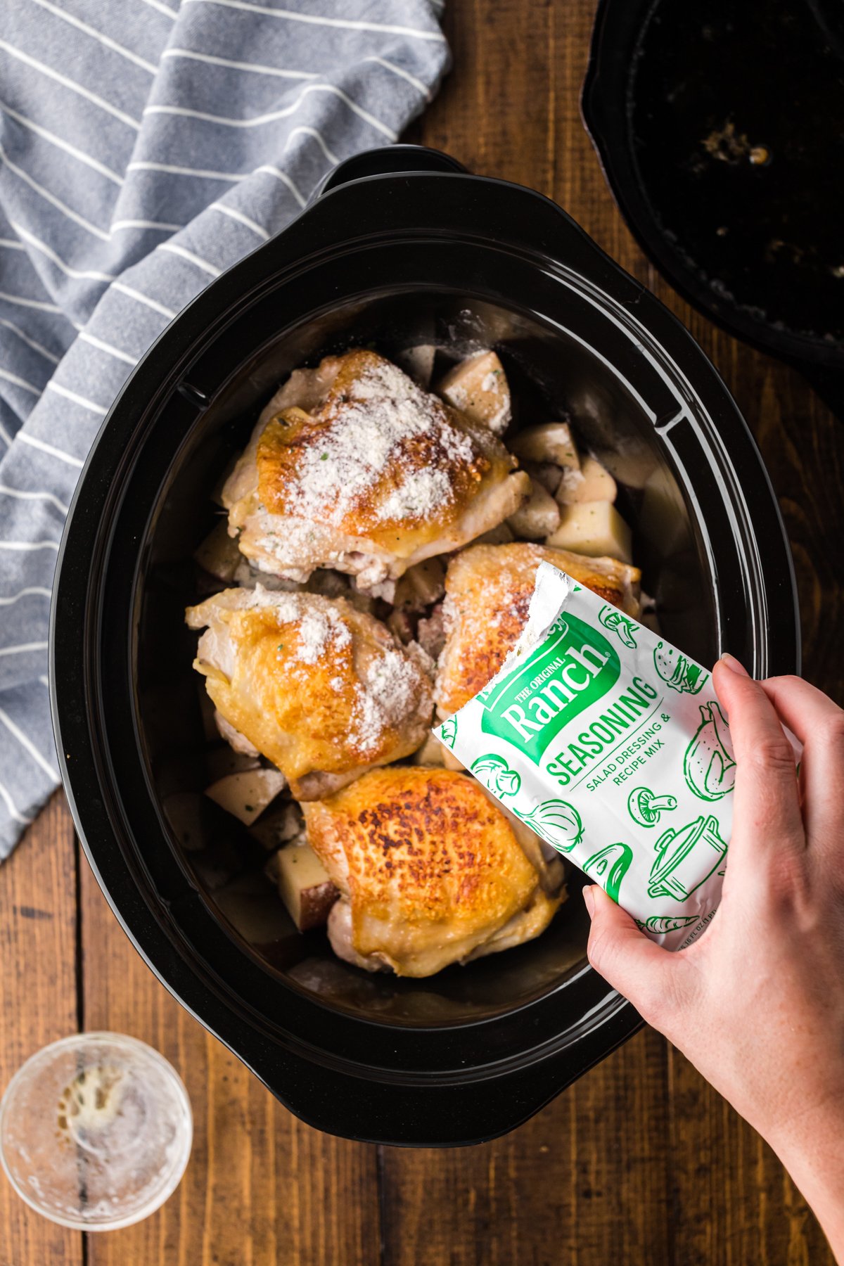 ranch being sprinkled over the chicken.