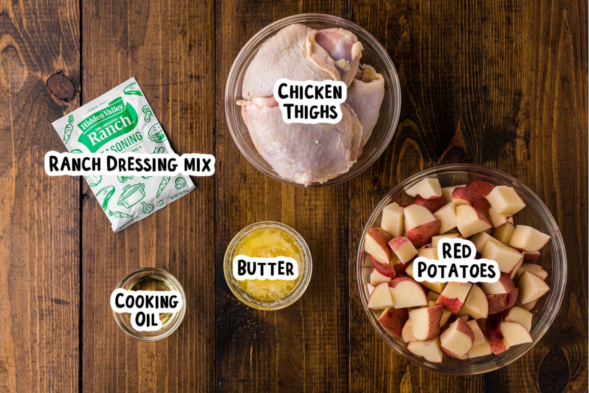 Ingredients for ranch chicken and potatoes on a table with text labels.
