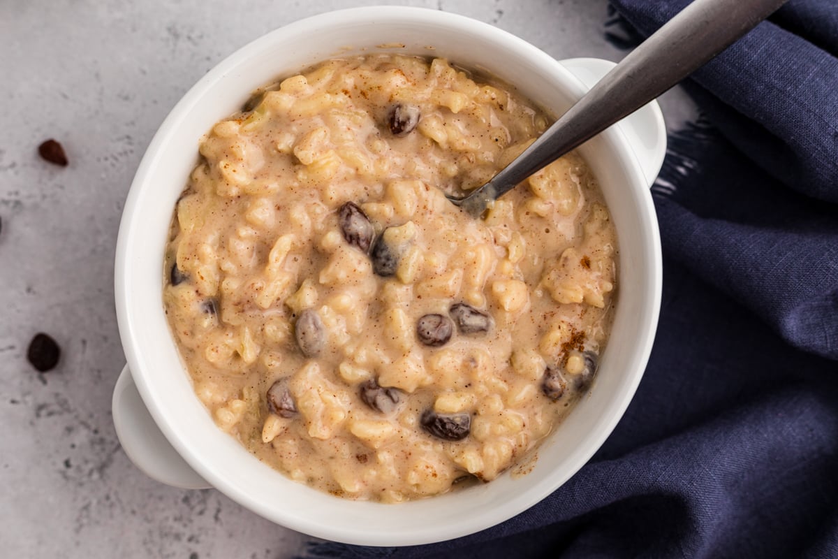 overhead shot of rice pudding with raisins in a bowl.