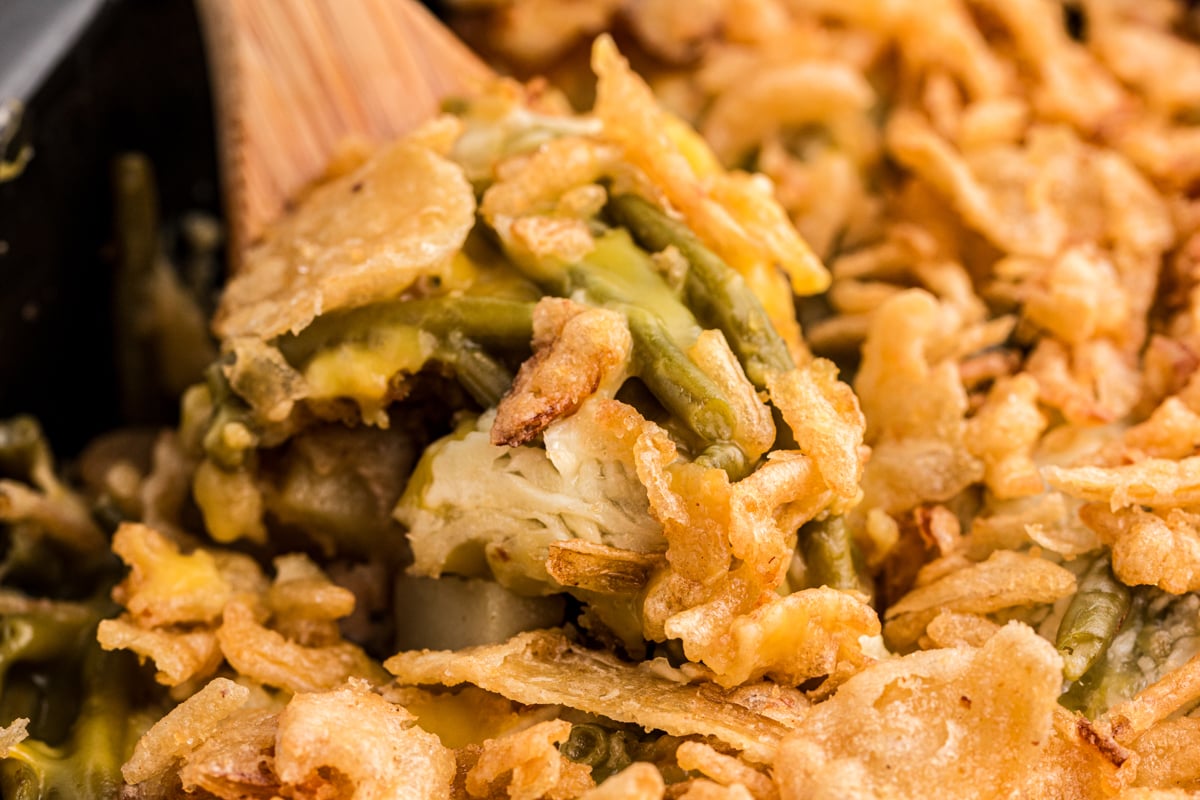 thanksgiving casserole close up shot in slow cooker with wooden spoon.