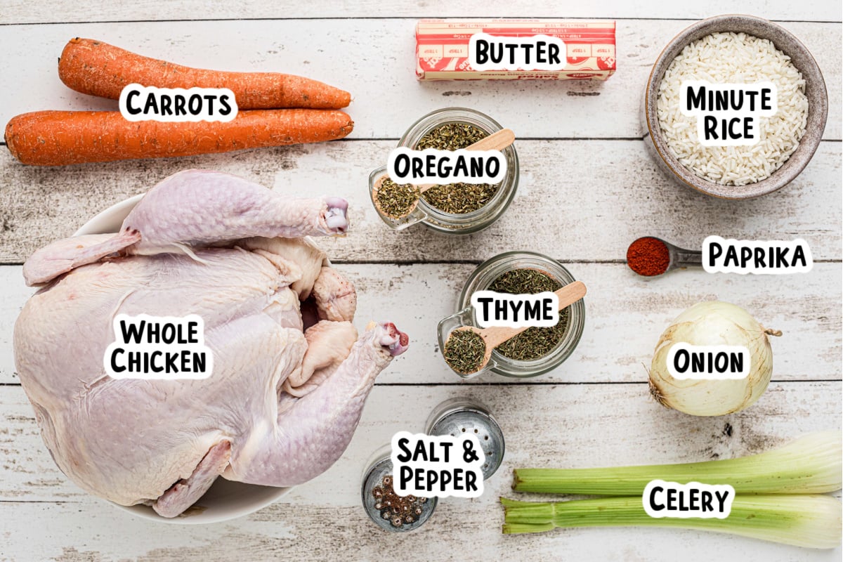 Ingredients for whole chicken and rice on a table.