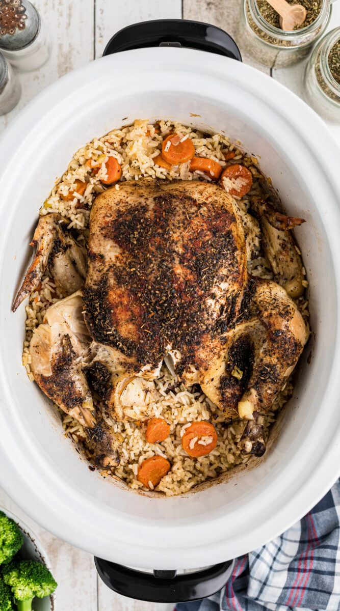 Long image of chicken and rice in a slow cooker.