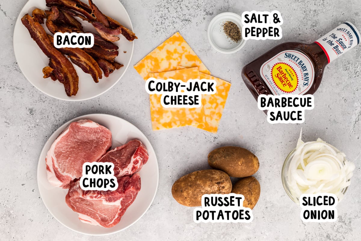 overhead of ingredients to make slow cooker barbecue pork chops and potatoes on a table.