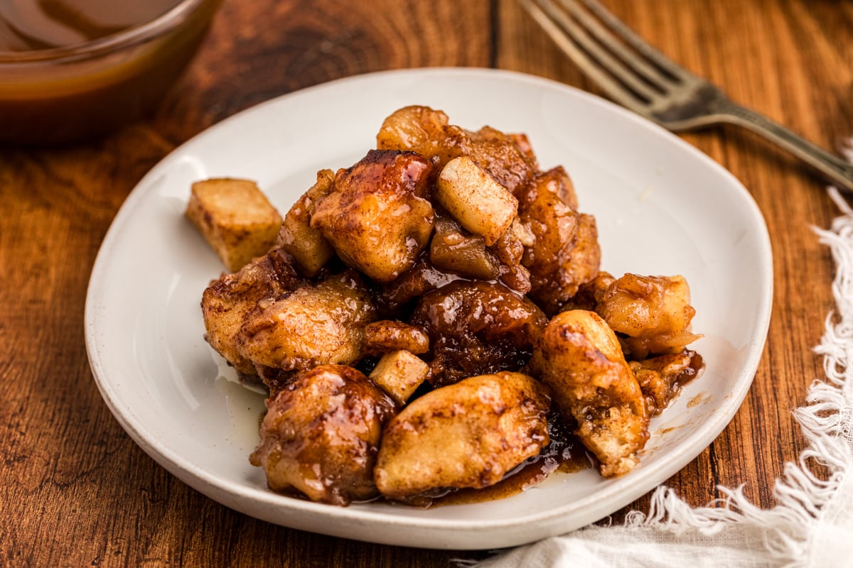 serving of slow cooker caramel apple cinnamon roll casserole on a plate.