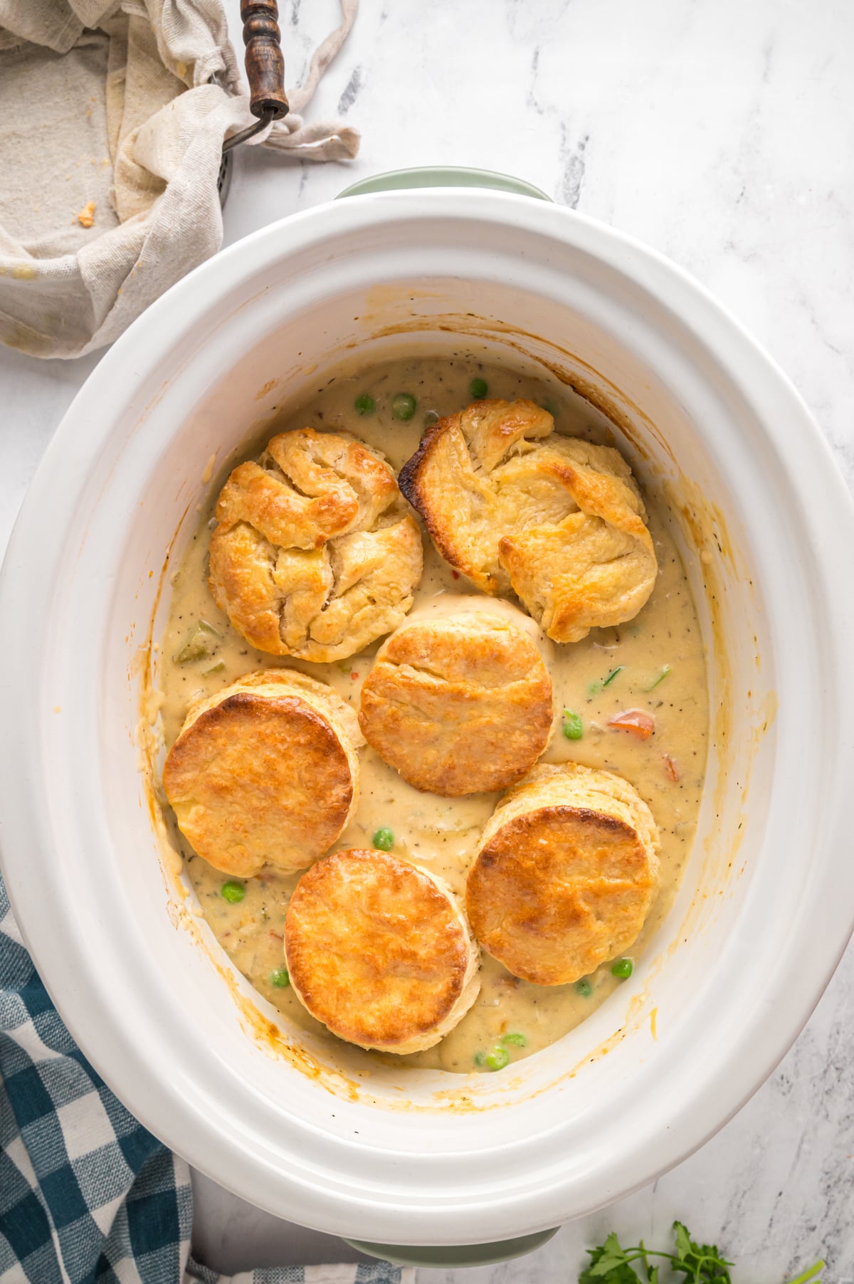 biscuits on top of chicken pot pie in slow cooker.