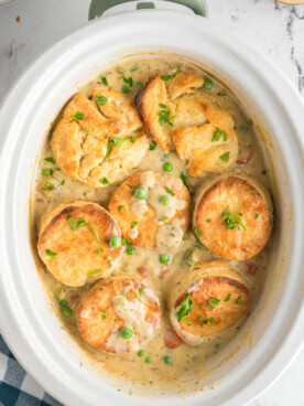 long image of chicken pot pie in a crockpot.