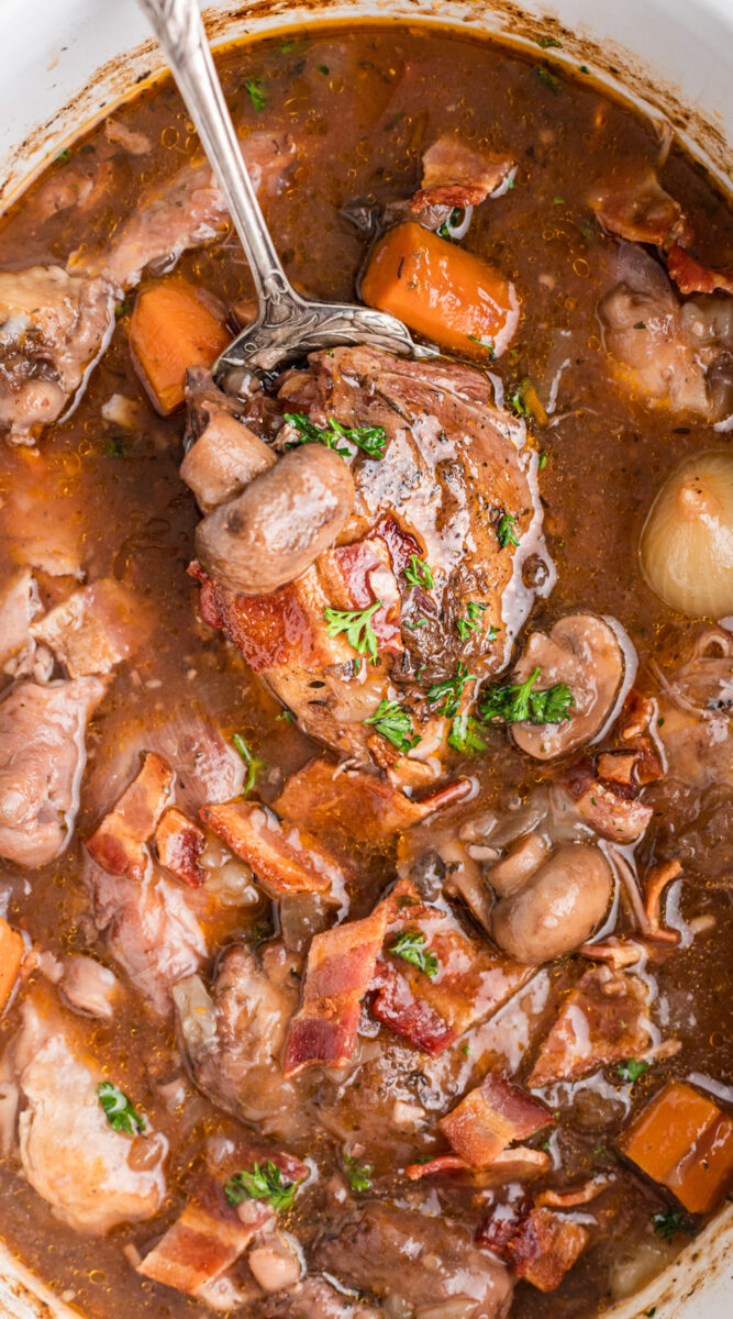 long image of coq au vin in a slow cooker.