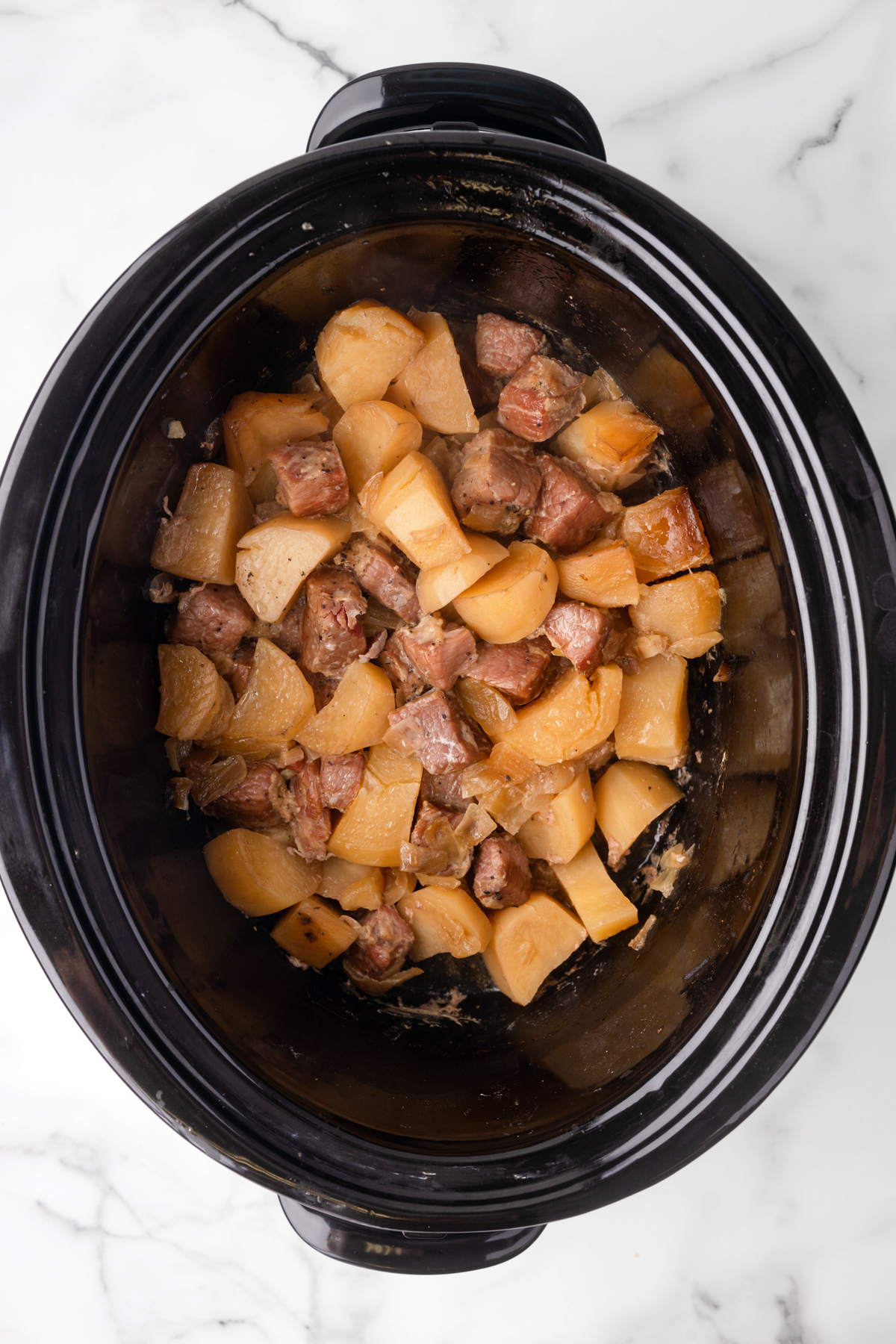 Corned beef and potatoes in a slow cooker.