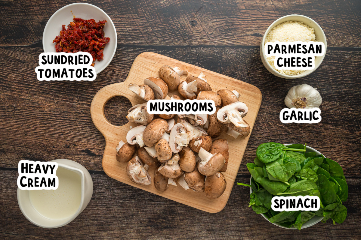 overhead of ingredients for slow cooker tuscan mushrooms on a wooden surface.