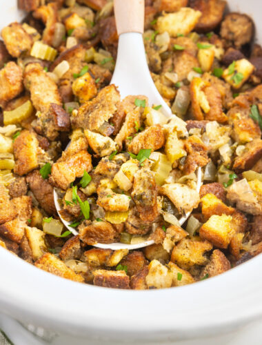 cooked stuffing in a white slow cooker.