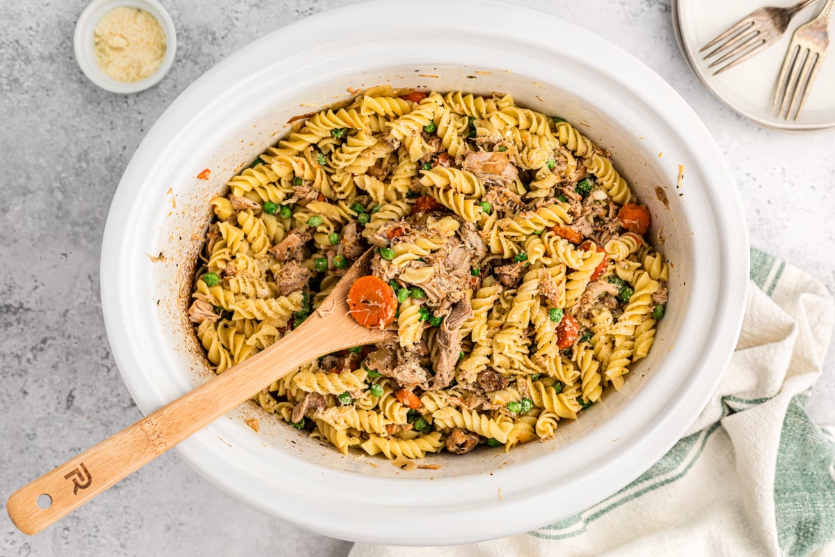 overhead shot of garlic butter chicken and pasta in a crockpot.