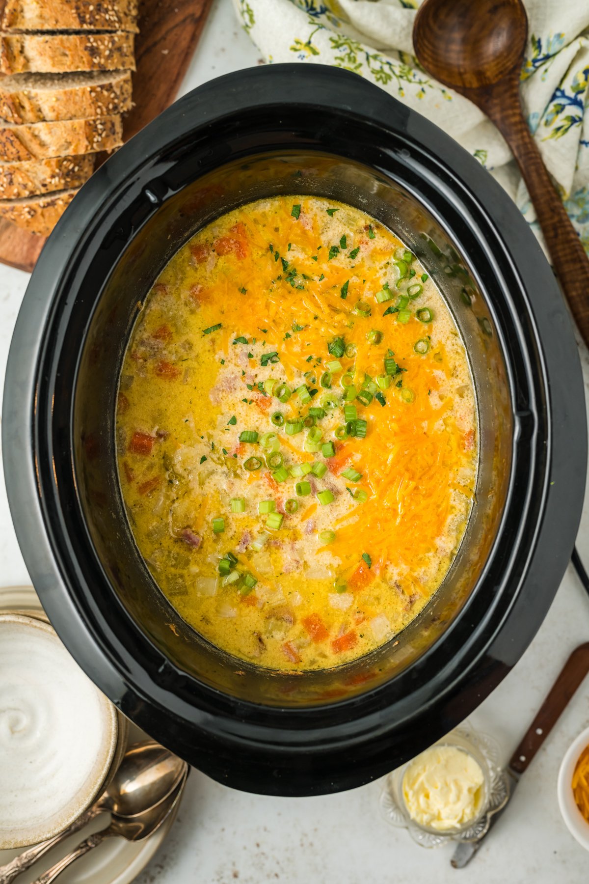 overhead of ham and potato soup in a slow cooker.