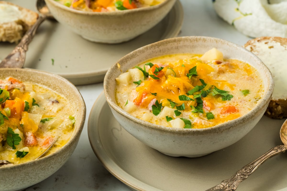 slow cooker ham and potato soup in individual serving bowls.