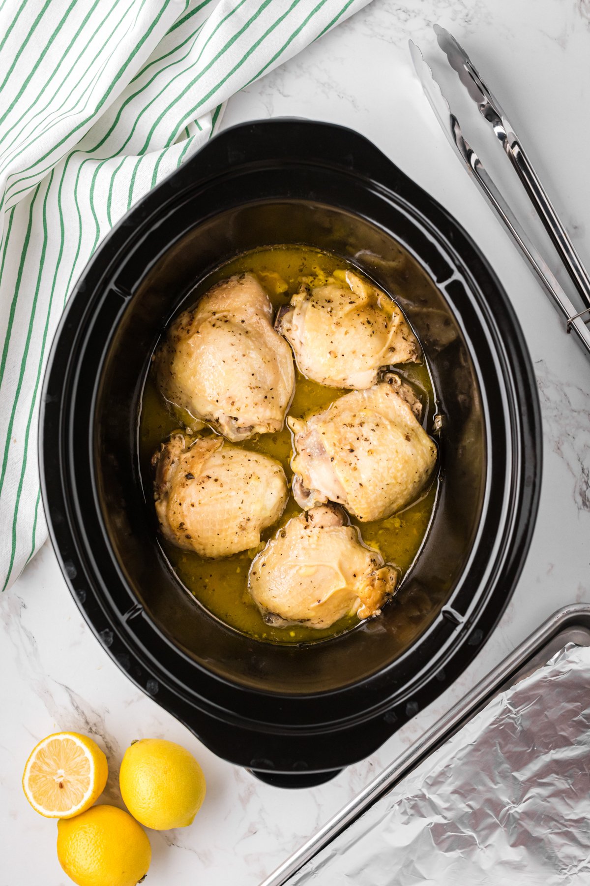CHICKEN THIGHS IN A SLOW COOKER WITH A LEMON SAUCE.