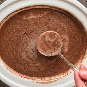 hot chocolate with Nutella in a white slow cooker.