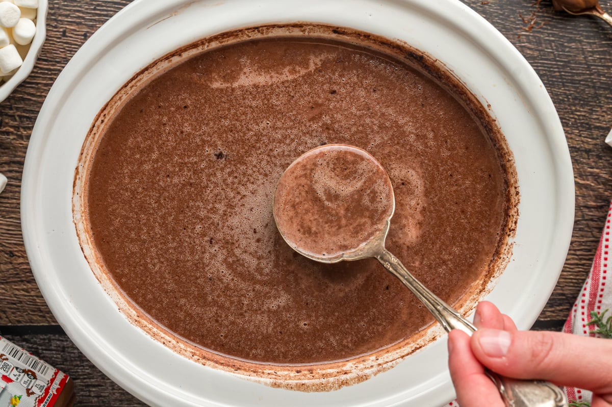 hot chocolate with Nutella in a white slow cooker.