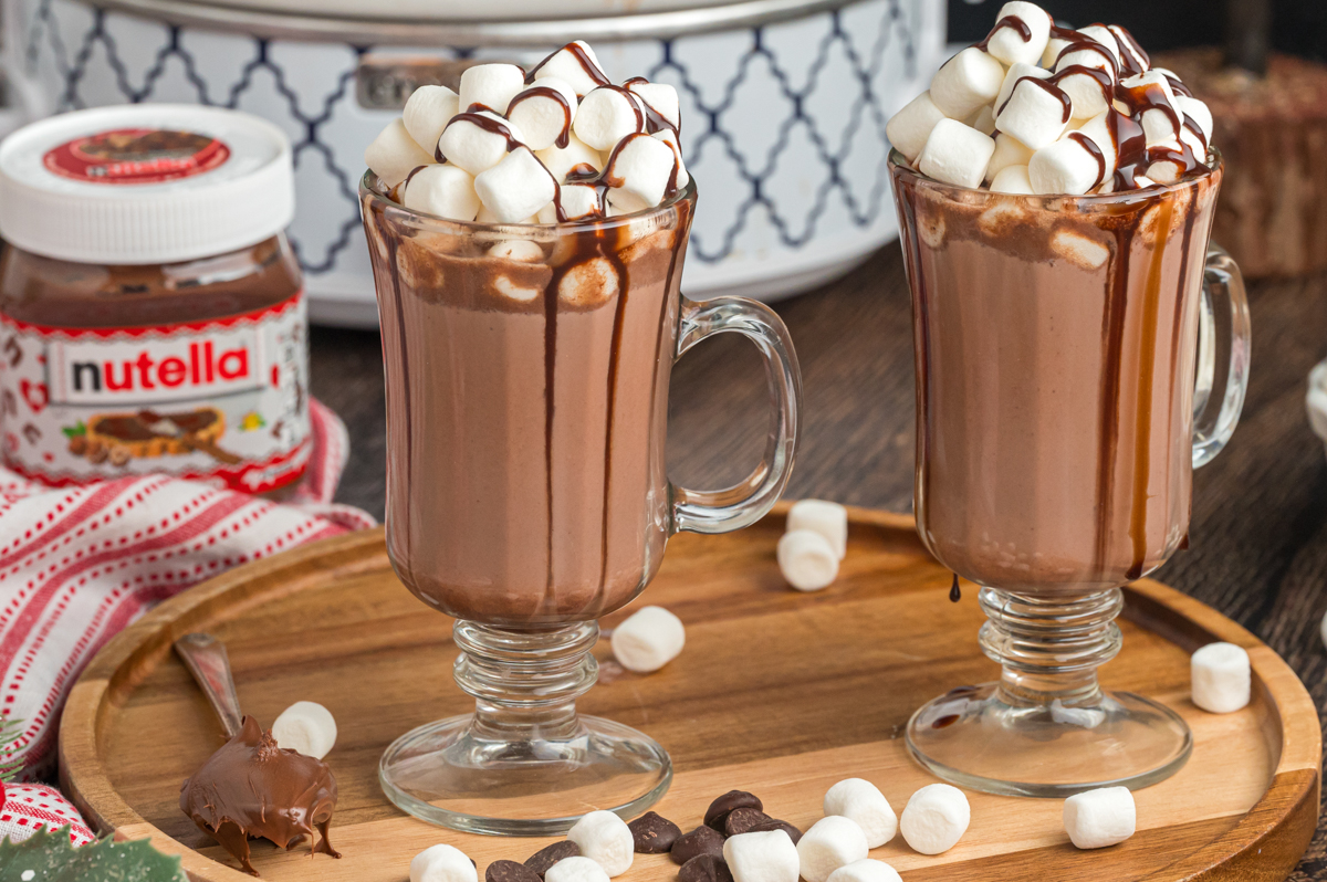 nutella hot chocolate in clear mugs with mini marshmallows.