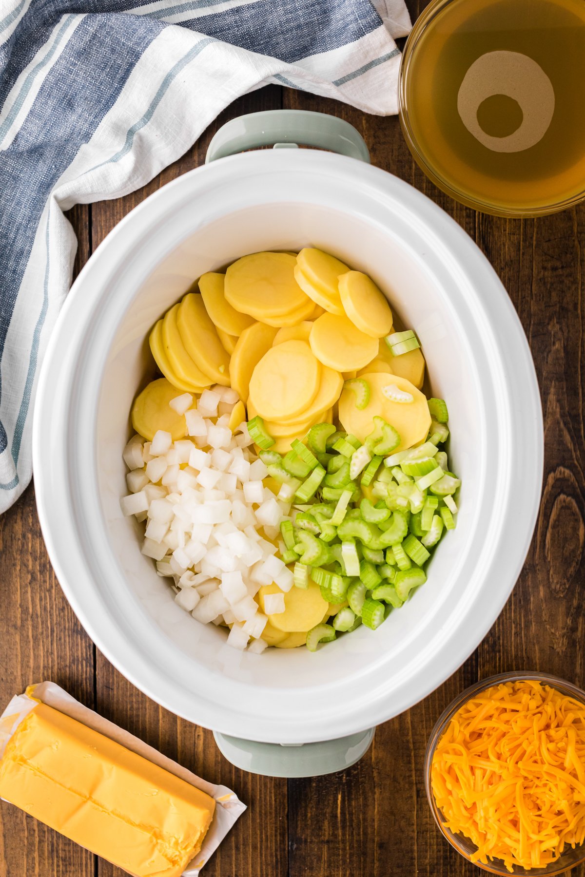 Ingredients for potato cheese soup in a slow cooker.