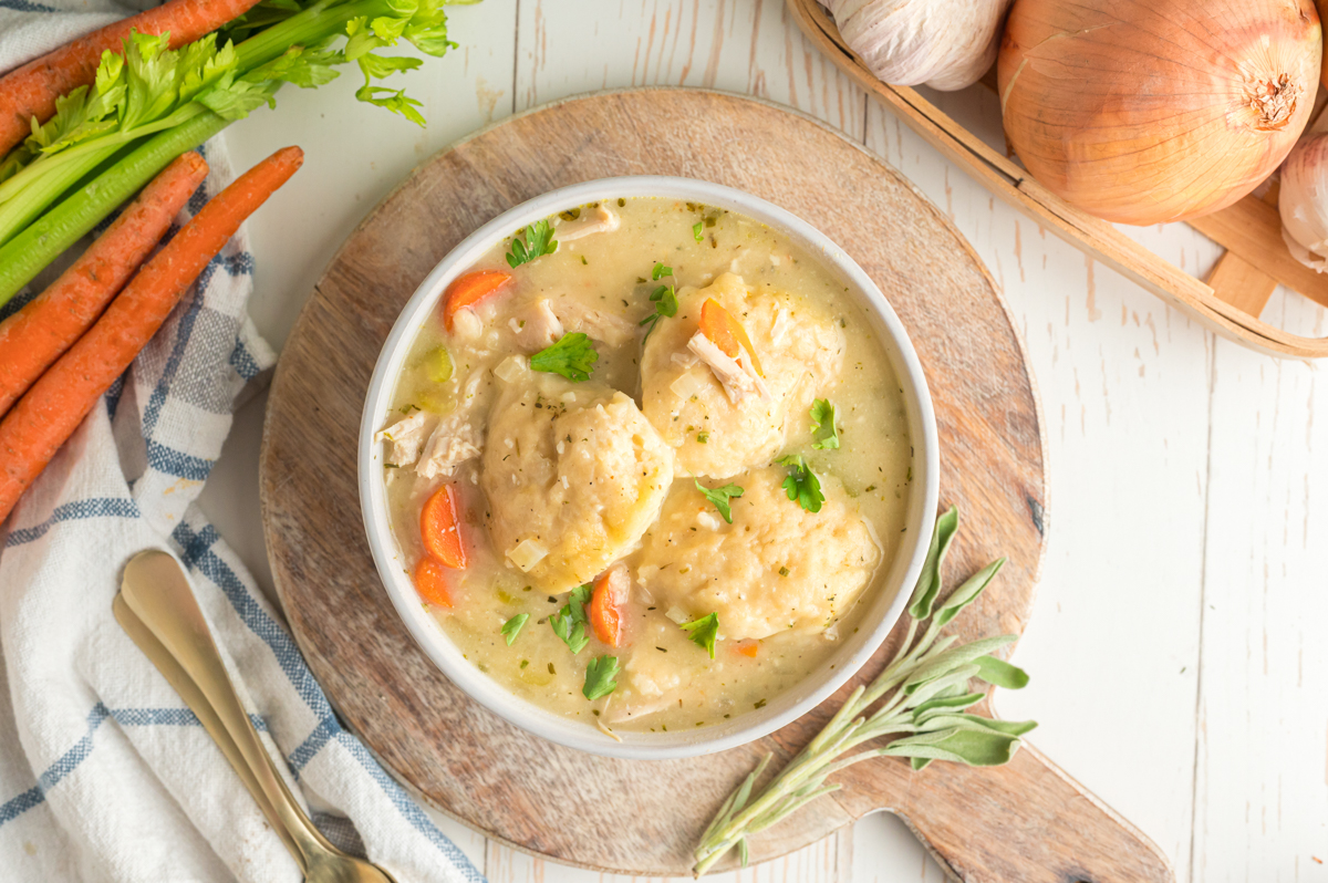 Bowl of turkey and dumplings on a small cutting board.