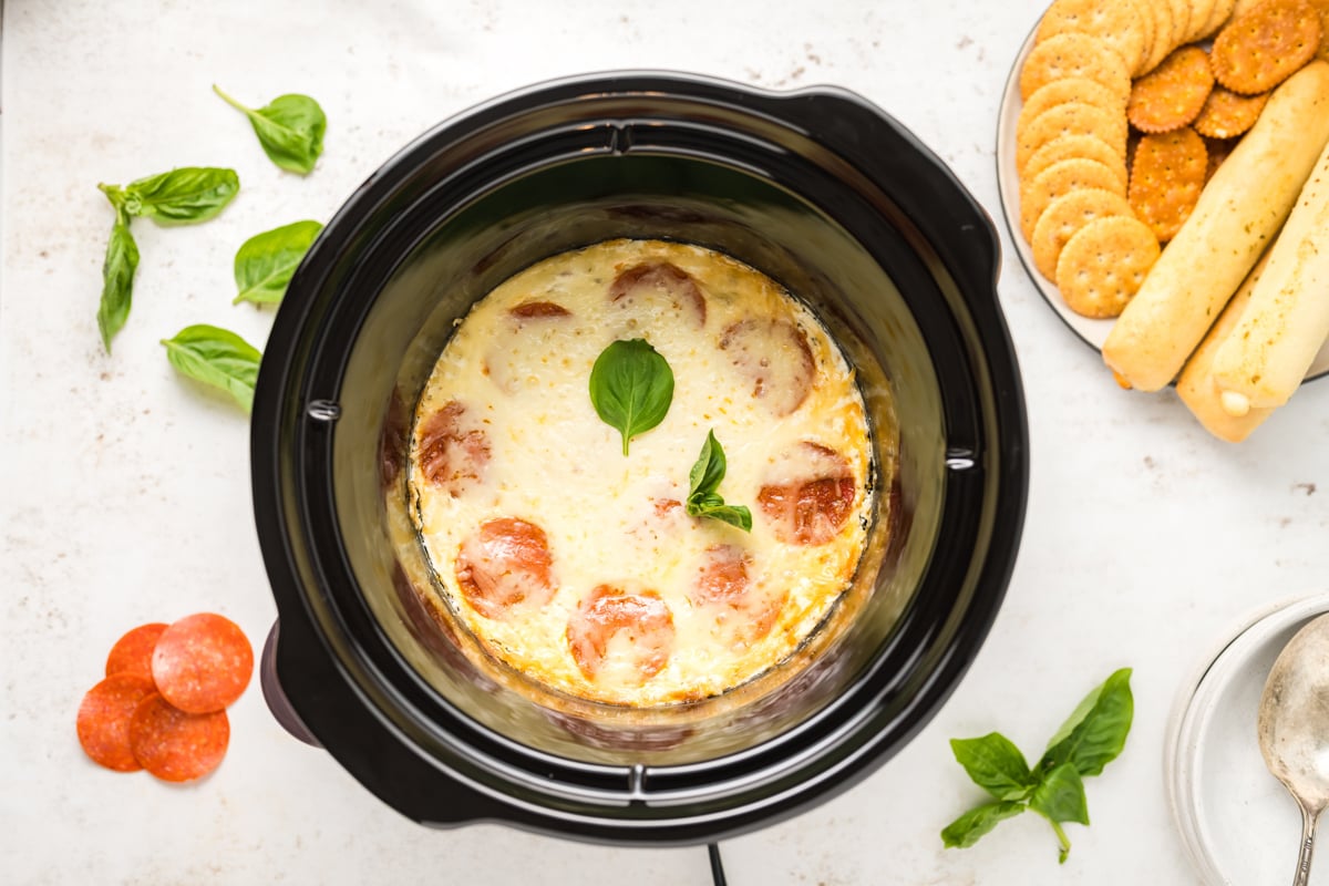 overhead of white pizza dip in a slow cooker.