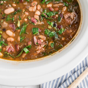 overhead of slow cooker 15 bean soup with ham and collard greens.