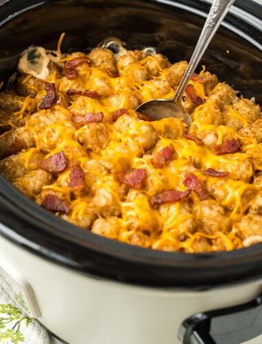tater tot casserole with bacon on top in a slow cooker.