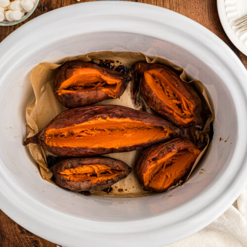 overhead of baked sweet potatoes in a slow cooker.