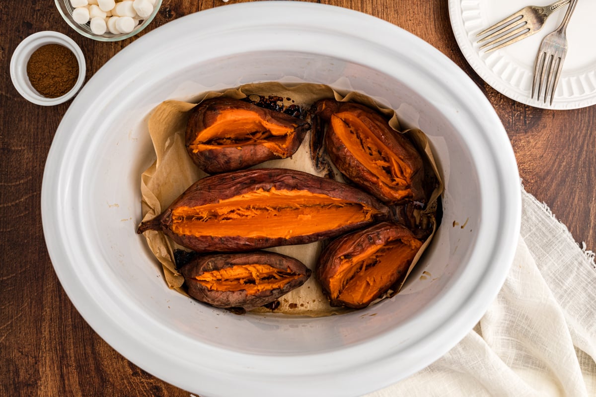 overhead of baked sweet potatoes in a slow cooker.