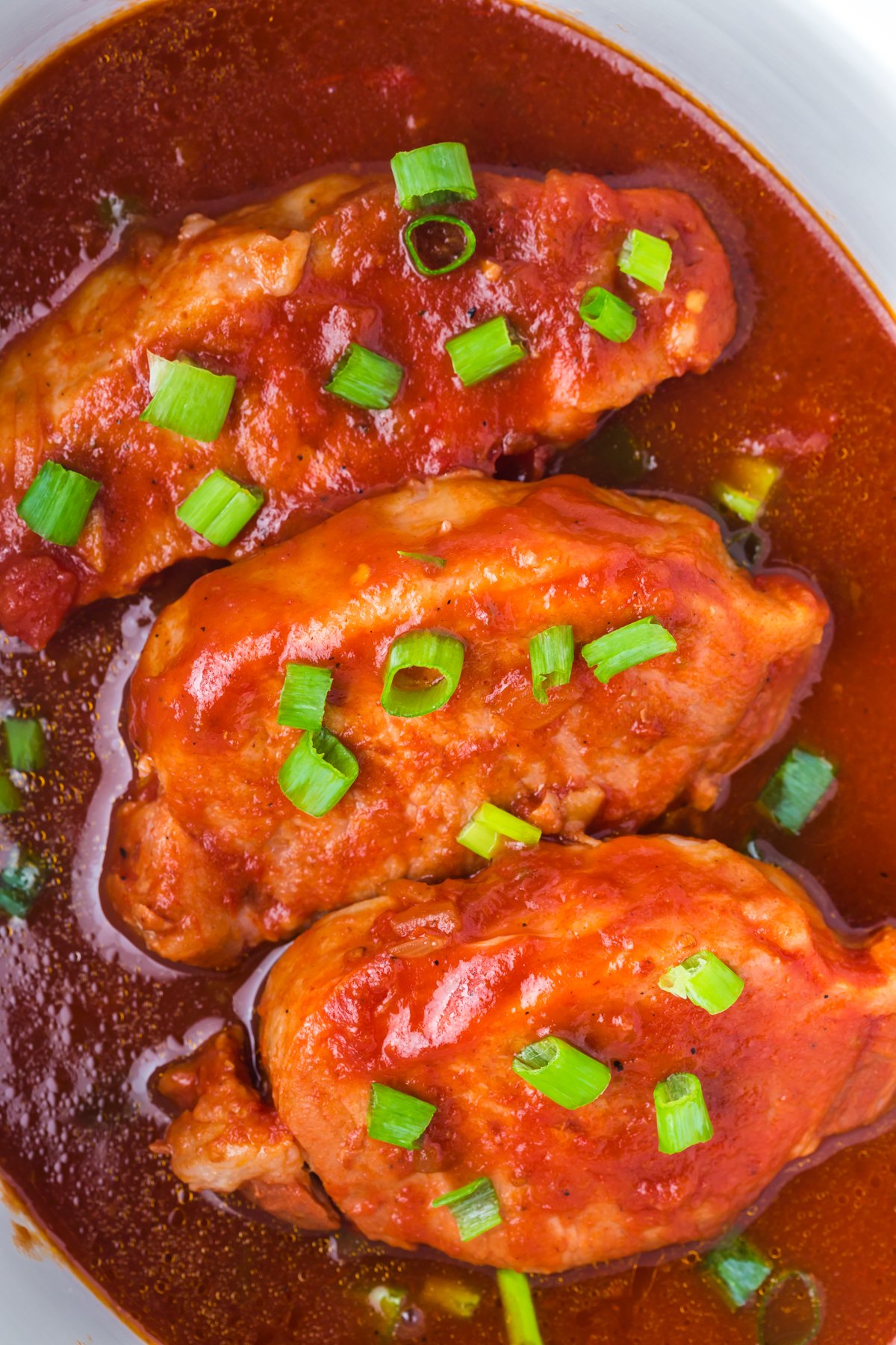 close-up overhead of bbq pork chops in the slow cooker.