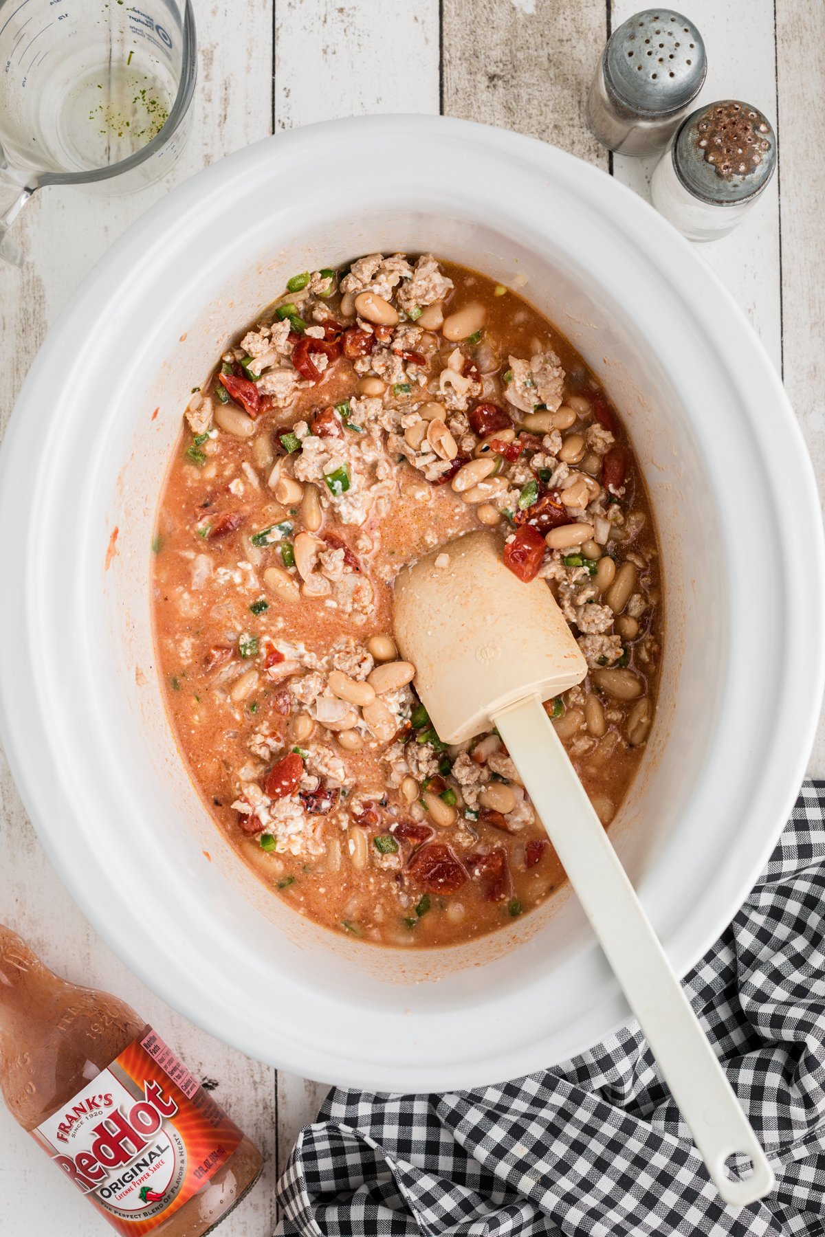 uncooked buffalo chicken chili in a slow cooker.