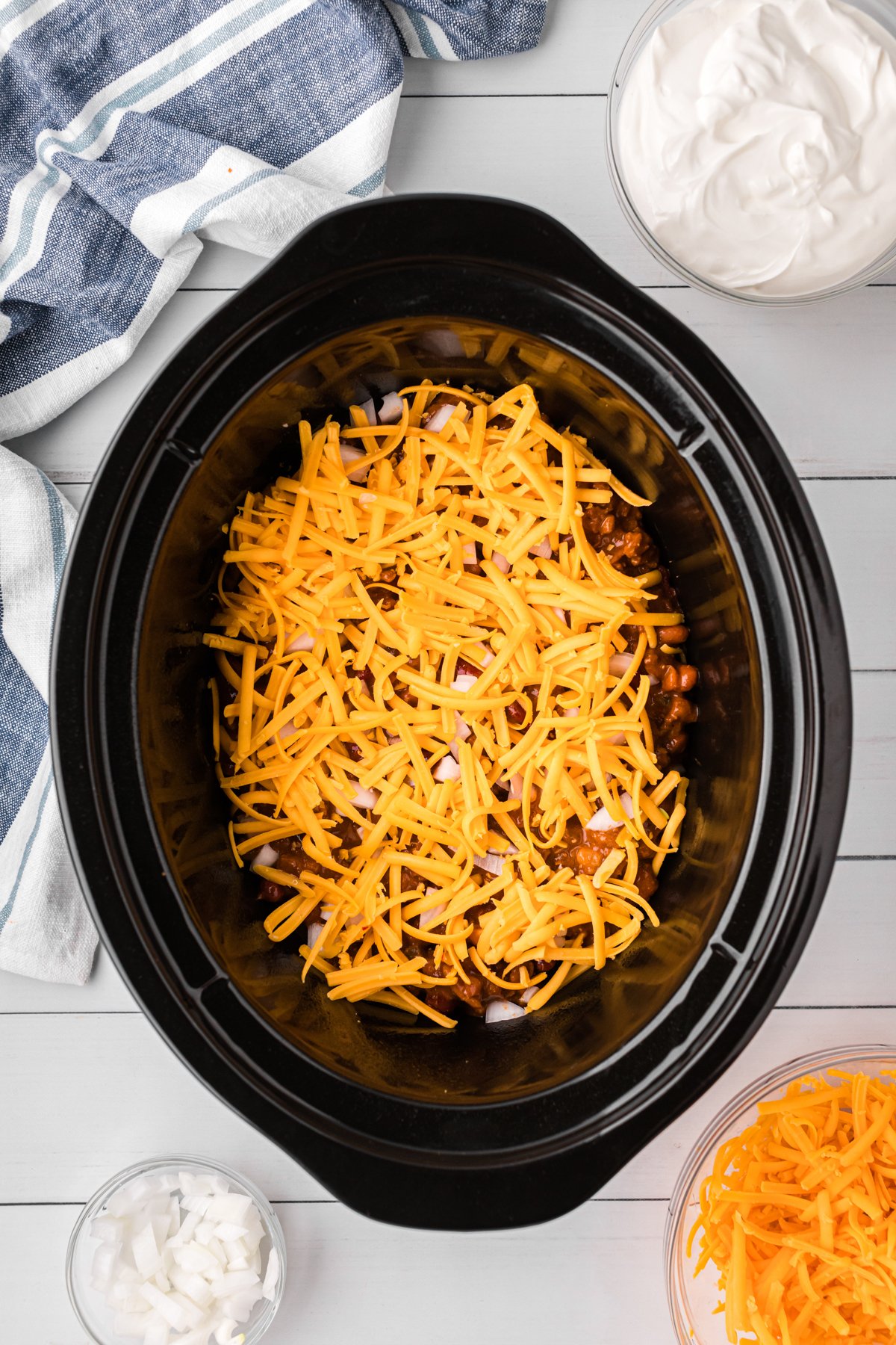 chili, onions and cheese in a slow cooker.