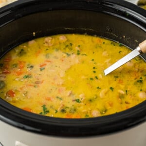 cooked pickle soup in a black crockpot.